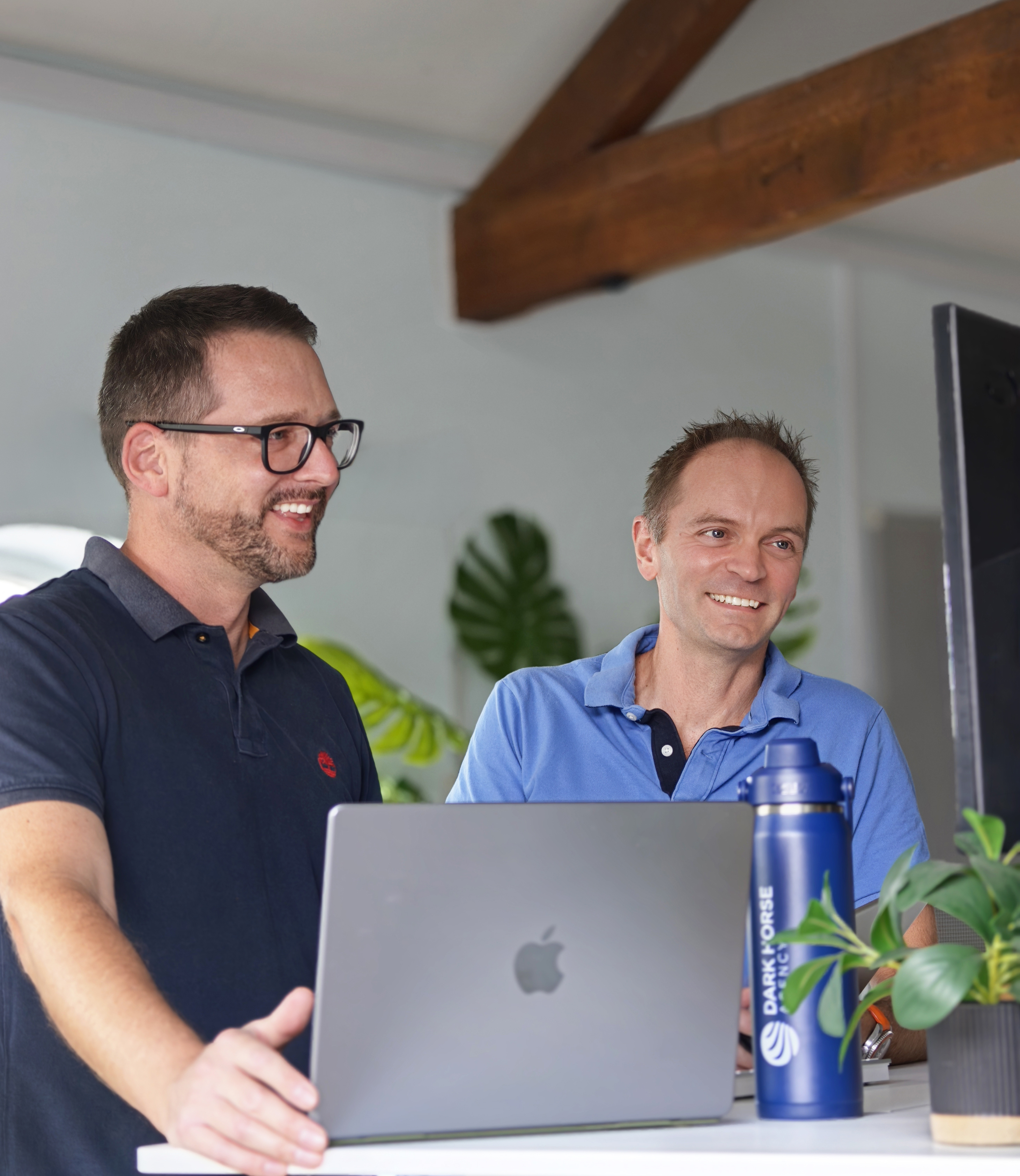 Two Dark Horse colleagues reviewing work together on a laptop